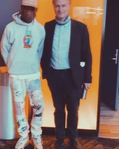 Travis Scott and Christopher Nolan posing together in a studio