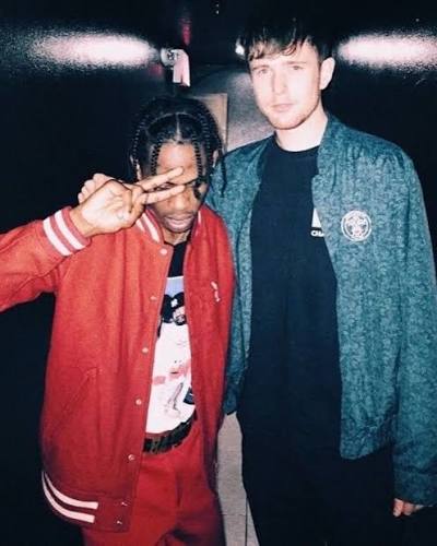 Travis Scott and James Blake standing together at an event